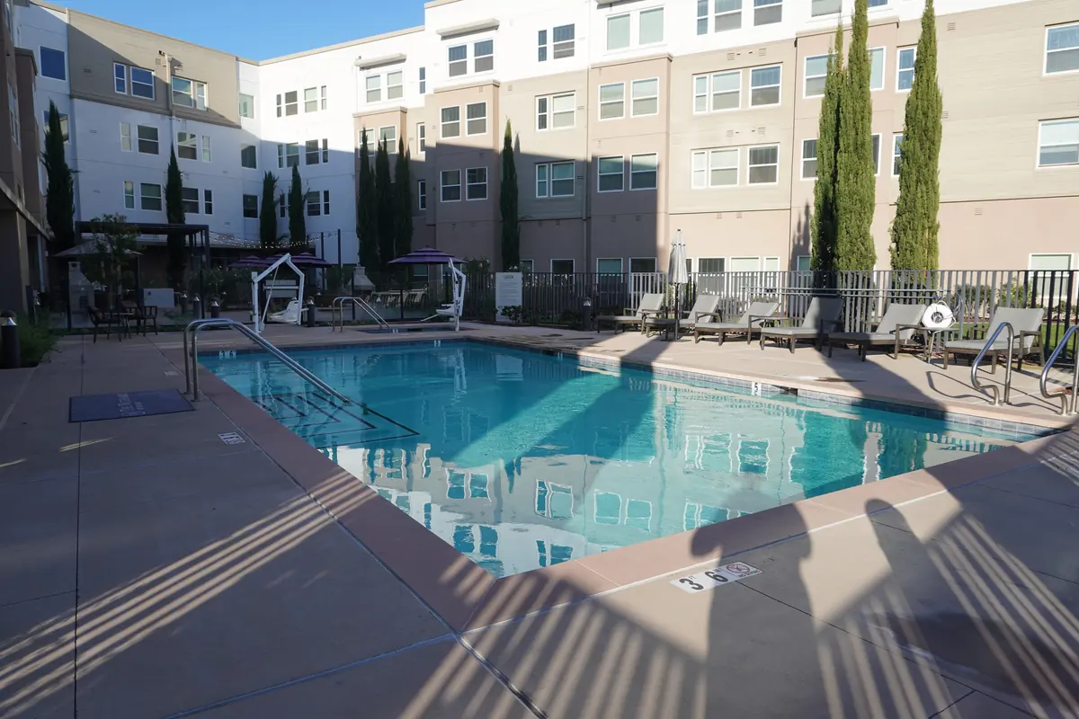 A courtyard pool reflecting the building beside it.