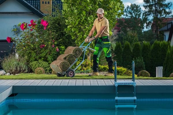 Man is working on Pool Side at a Customer Home - Genie Pool and Spa.